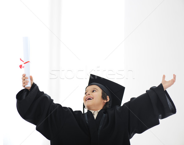 Happy successful kid with diploma and graduating clothes Stock photo © zurijeta