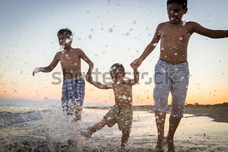 Fun kids playing splash at beach Stock photo © zurijeta