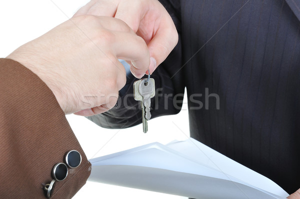 Two businessmen hands and the key, paper agreement Stock photo © zurijeta