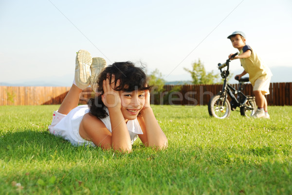 Stock photo:  Happy children on beautiful green meadow 