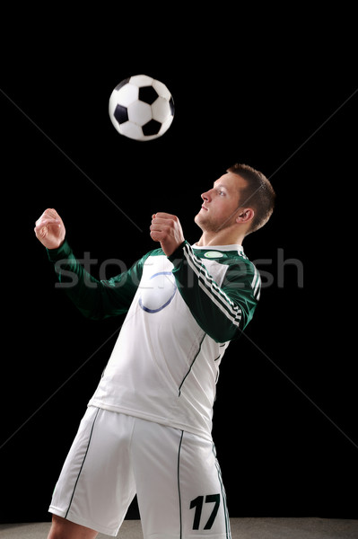 Footballer on black background Stock photo © zurijeta