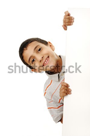 Portrait of a happy little boy holding a blank board against white background Stock photo © zurijeta