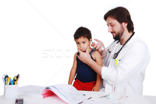 Young male doctor in white has some medical activities Stock photo © zurijeta