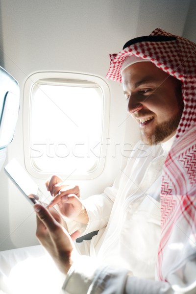 Modern Arabic businessman inside airplane Stock photo © zurijeta