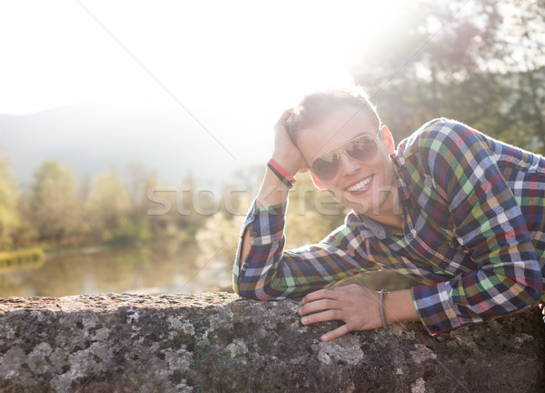 Young man on the old stone bridge with direct sunlight in backgr Stock photo © zurijeta