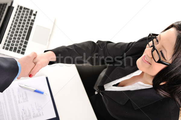Young and pretty secretary girl shake hand with office mate Stock photo © zurijeta