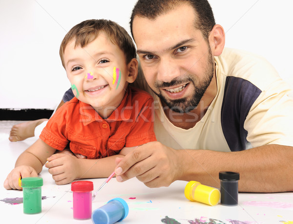 Father and kid playing with paint colors Stock photo © zurijeta