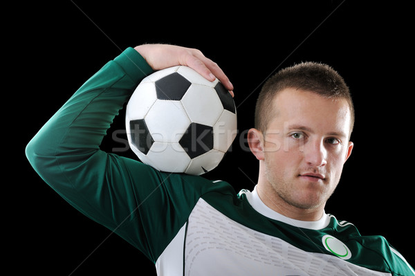 Proffessional footballer holding a ball on his shoulder Stock photo © zurijeta