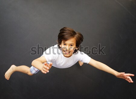 Stock photo: Kid jumping high up